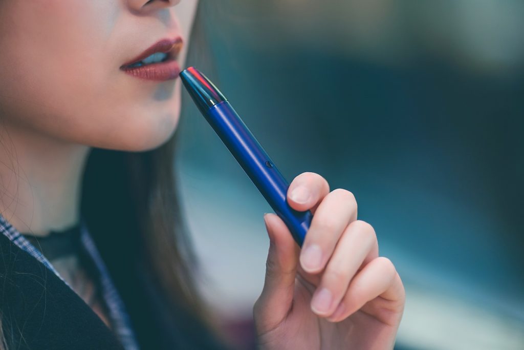 Girl vaping a vape pen